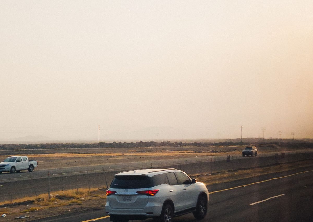 SUV on highway sunset